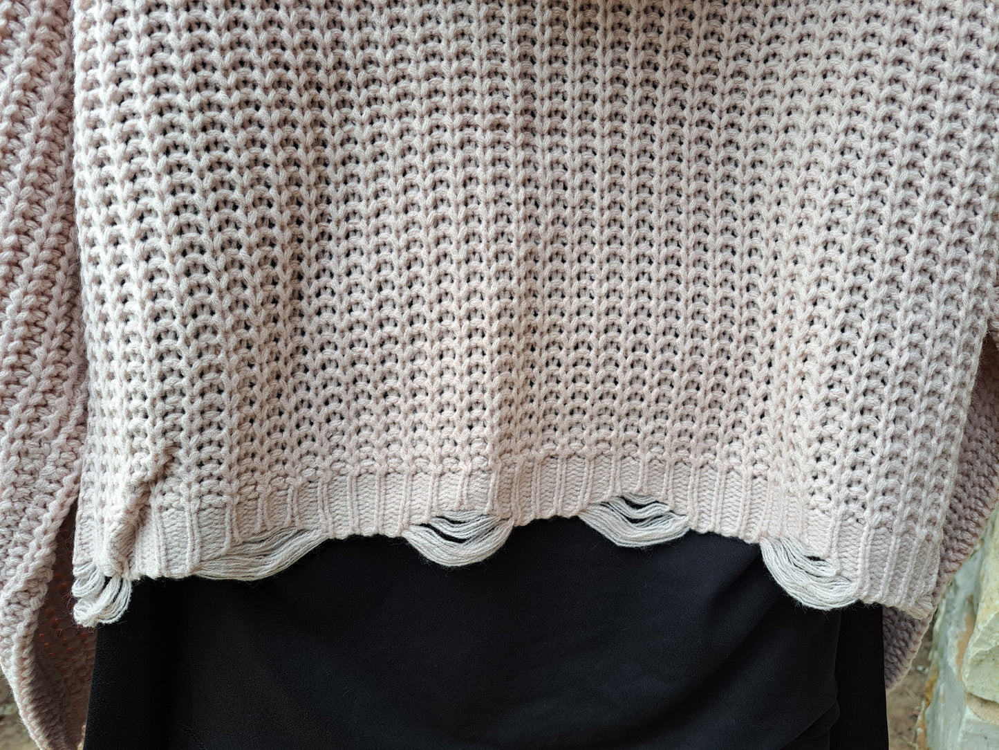 distressed hemline of sweater hoodie