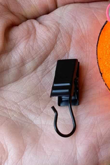 black metal vent clip held in hand