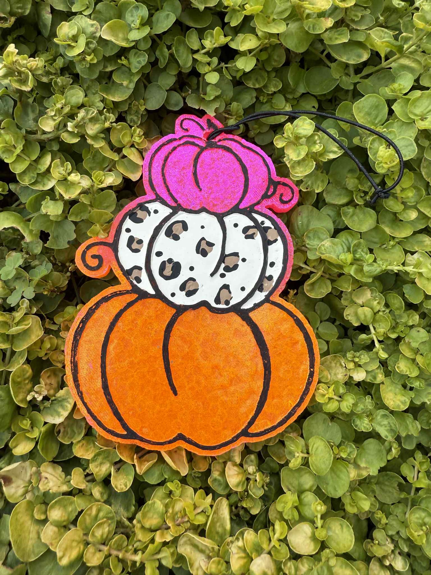 Orange pumpkin stack freshie with pink and leopard pumpkins. Greenery background