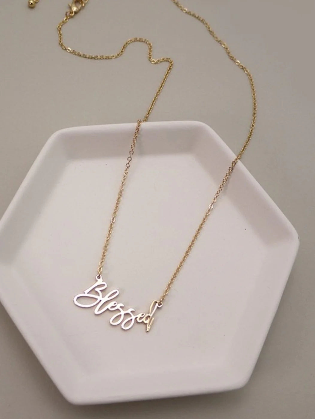 Blessed Script Necklace on dainty gold chain. White background