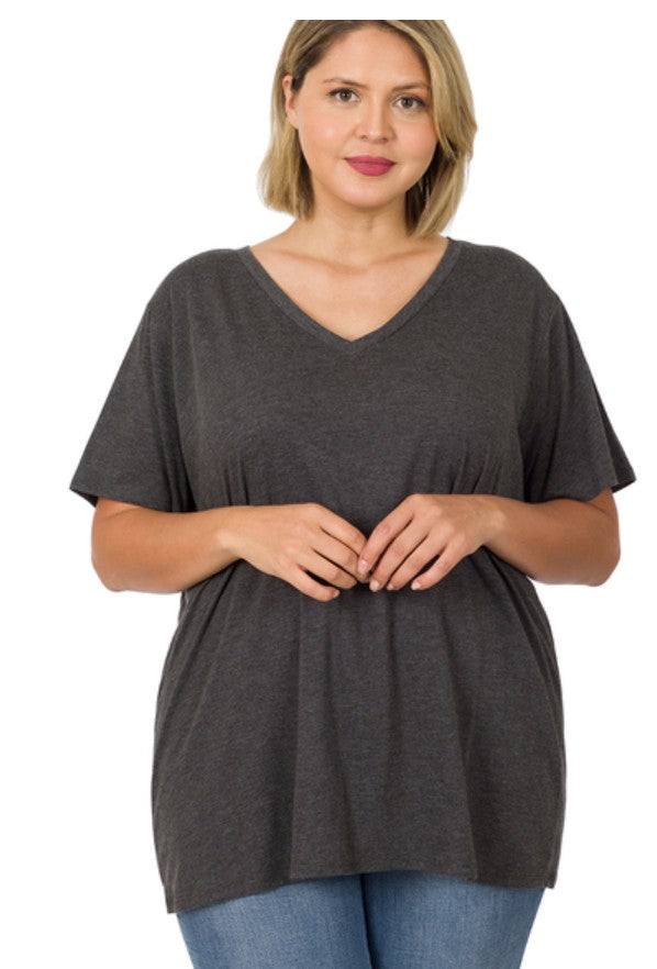 Woman wearing a dark gray t-shirt and blue jeans on a white background