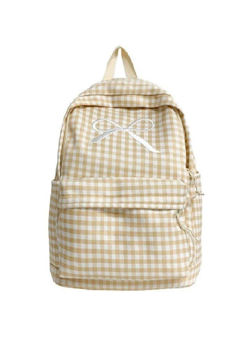 Beige and white checkered backpack with an embroidered bow on the front pocket.
