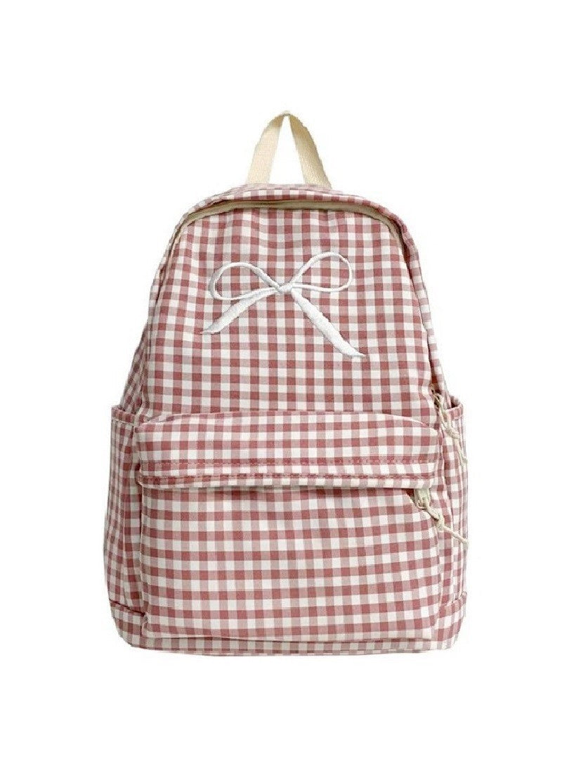 A pink and white checkered backpack with a embroidered bow on the front, featuring adjustable straps and a zip top closure.