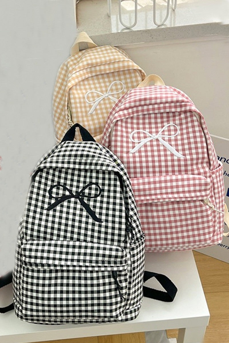 three checkered backpacks, front. Black and white, pink and white, cream and white