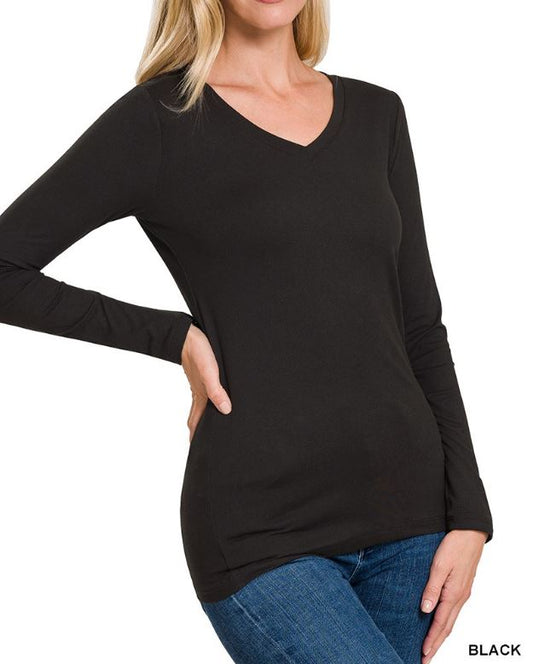 woman wearing black microfiber long sleeve top and jeans on a white background