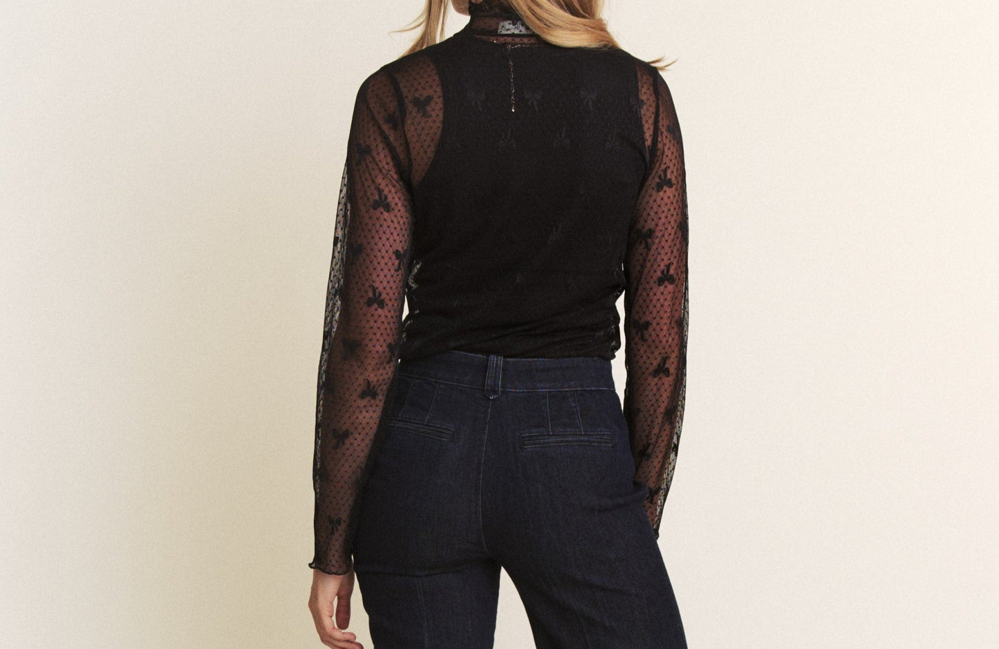 back of bow print sheer mesh top. White background