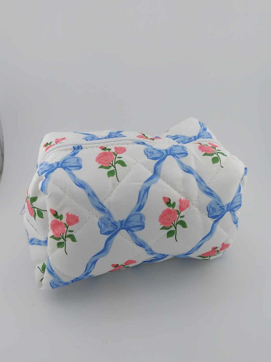 blue bow with roses cosmetic bag on a neutral background