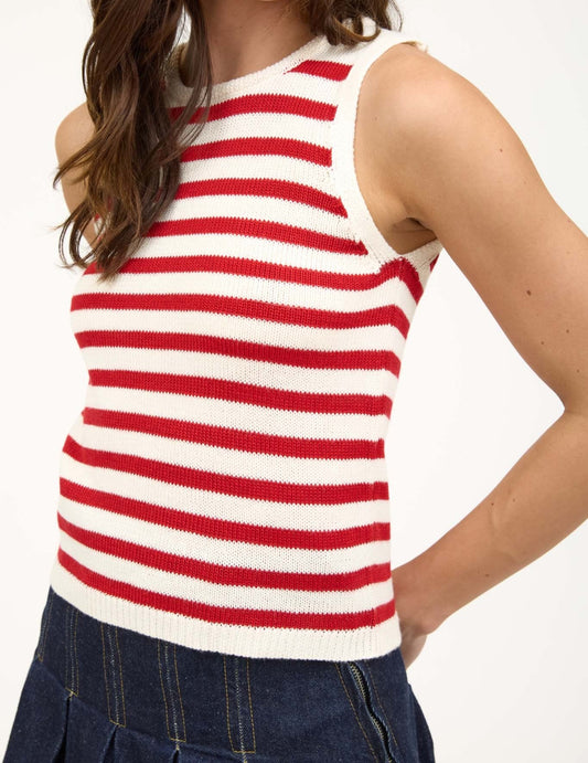 Woman wearing a red and white striped sleeveless top on a white background. Front view