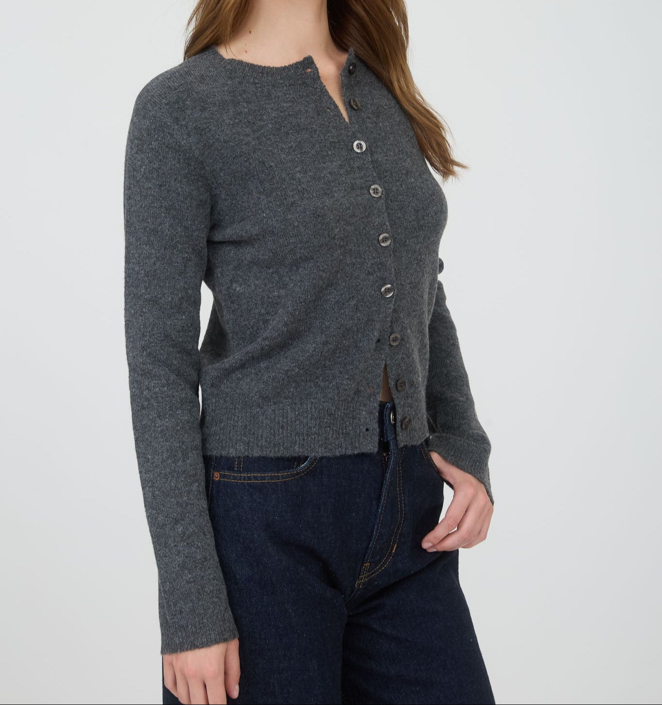 Woman wearing a gray cardigan on a white background