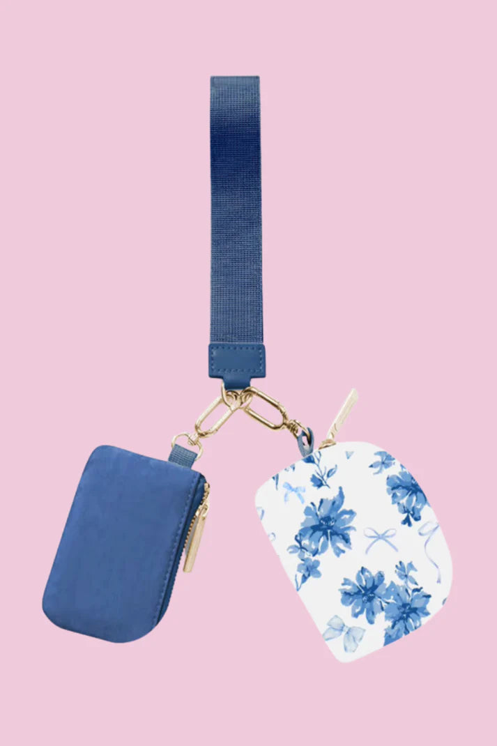 Blue pouch and floral and white print pouch on pink background