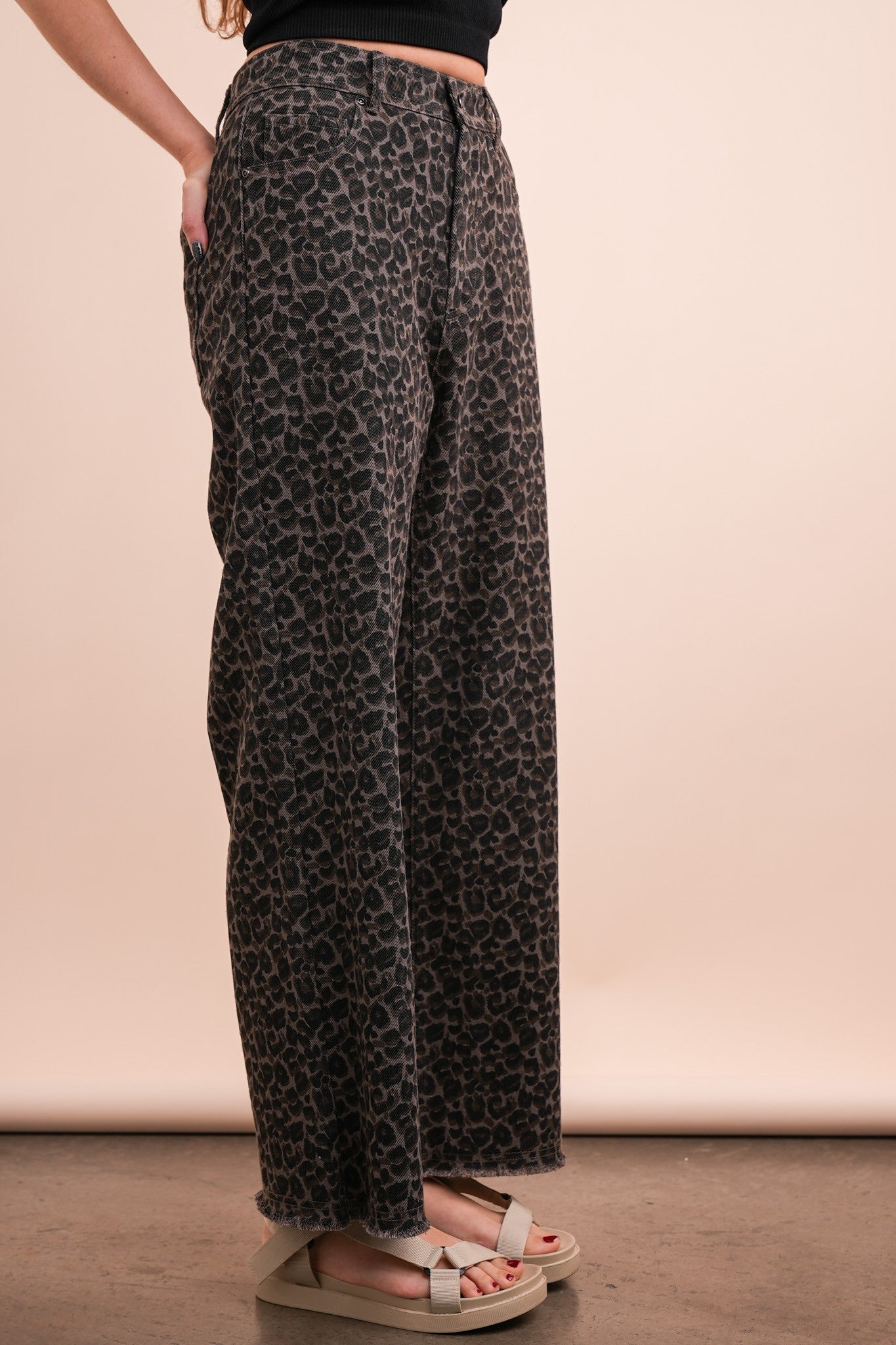 person wearing leopard jeans, side view