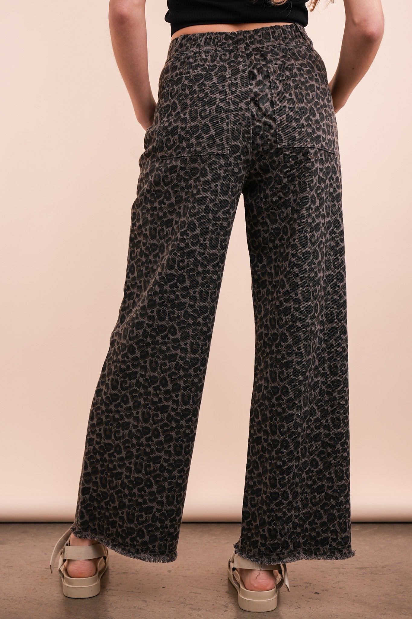 person wearing leoopard jeans, back