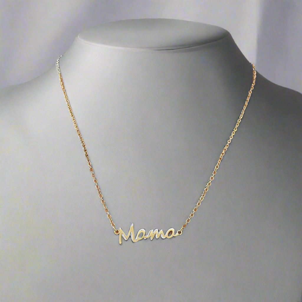 A gold-colored stainless steel necklace with the word 'Mama' inscribed on a chain, displayed on a person's neck.