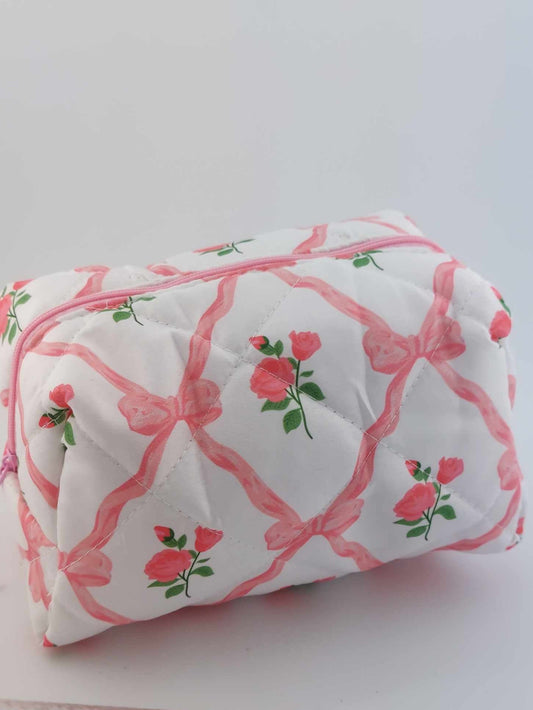 cosmetic bag with pink bows and roses on a neutral background