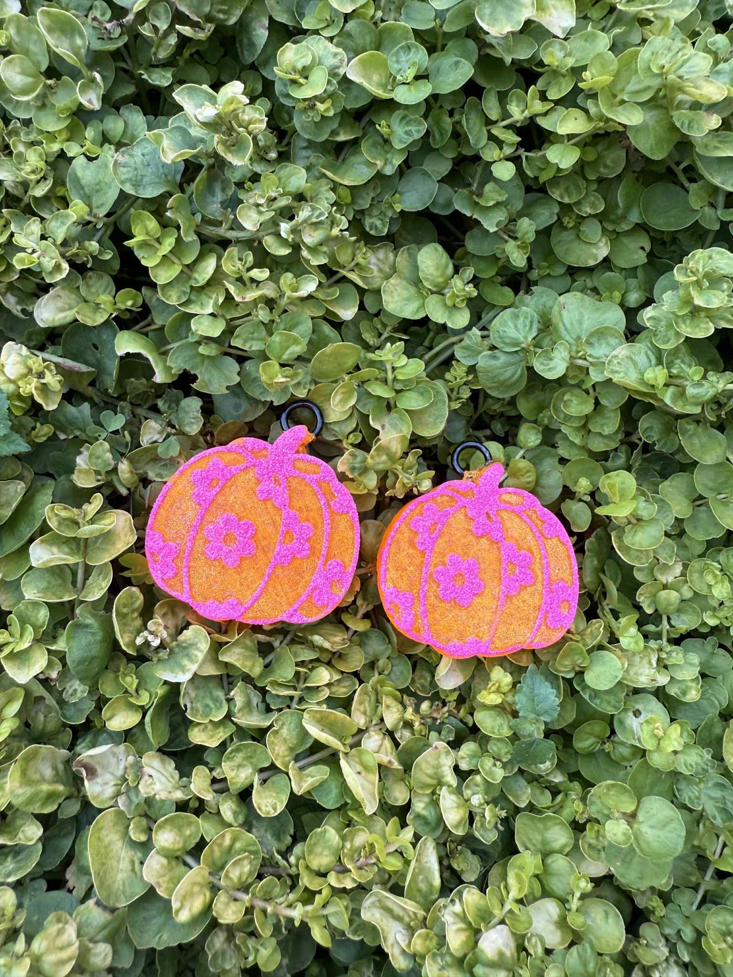 Pink and orange pumpkin vent clip freshies on green leaves