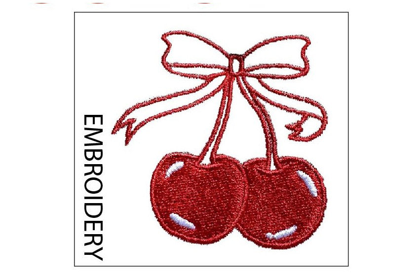 Embroidery design of two red cherries with a bow on a white background