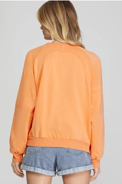 woman wearing long sleeve terry top. back view. white background