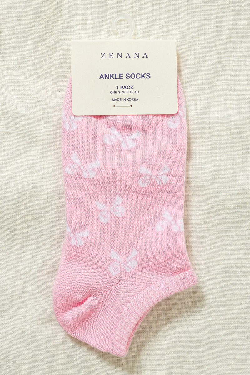 light pink ankle socks with white bow print. Beige background