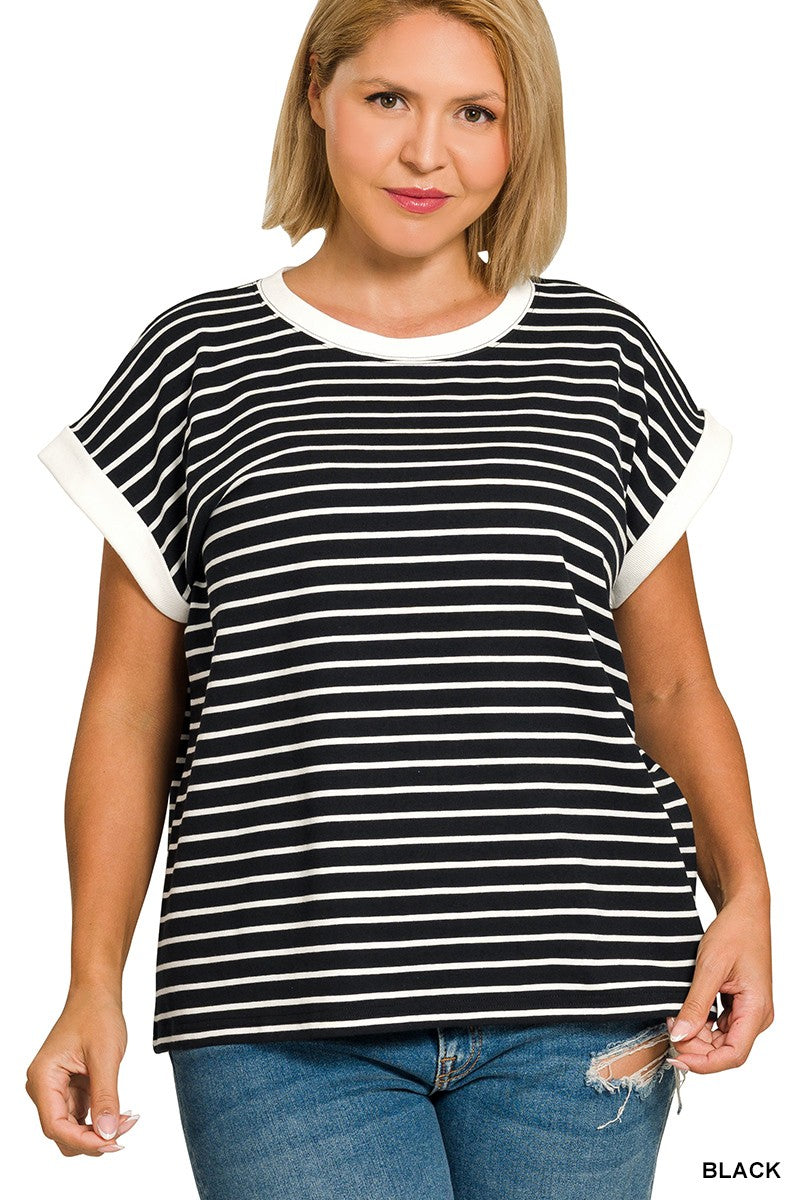Woman wearing a black and white striped shirt with blue jeans on a white background