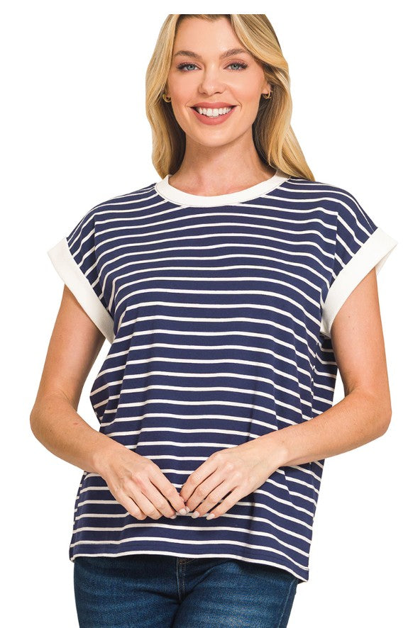 Woman wearing a navy and white striped shirt on a white background