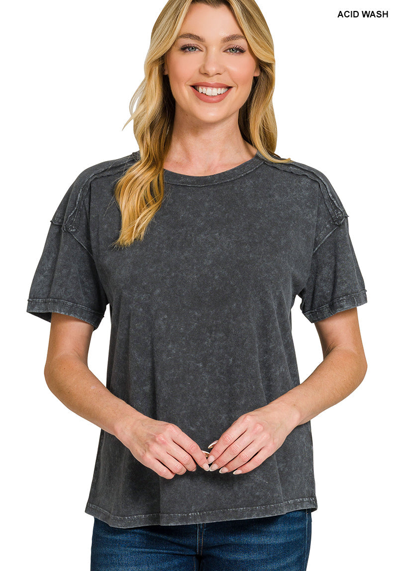 Woman wearing a black acid-wash t-shirt on a white background