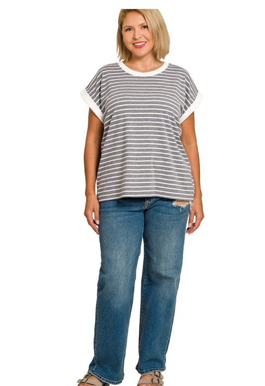 Woman wearing a striped shirt and blue jeans on a white background