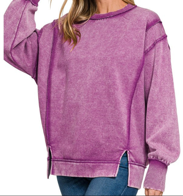 Woman wearing a purple fleece top on a white background