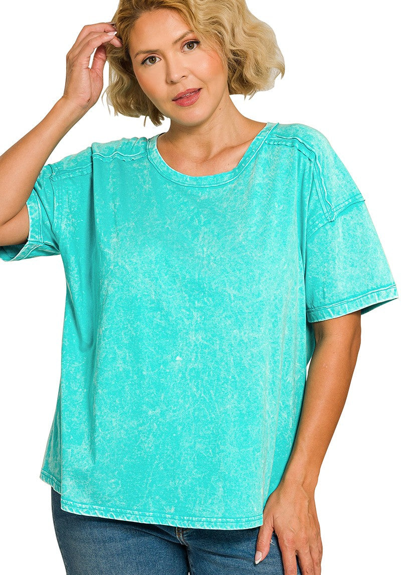 Woman wearing a turquoise t-shirt on a white background