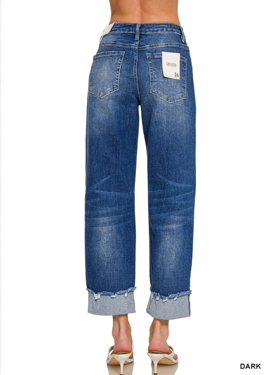 Blue jeans with a visible brand label on a white background