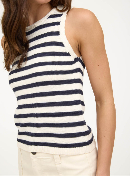 Woman wearing a striped sleeveless top with a plain background