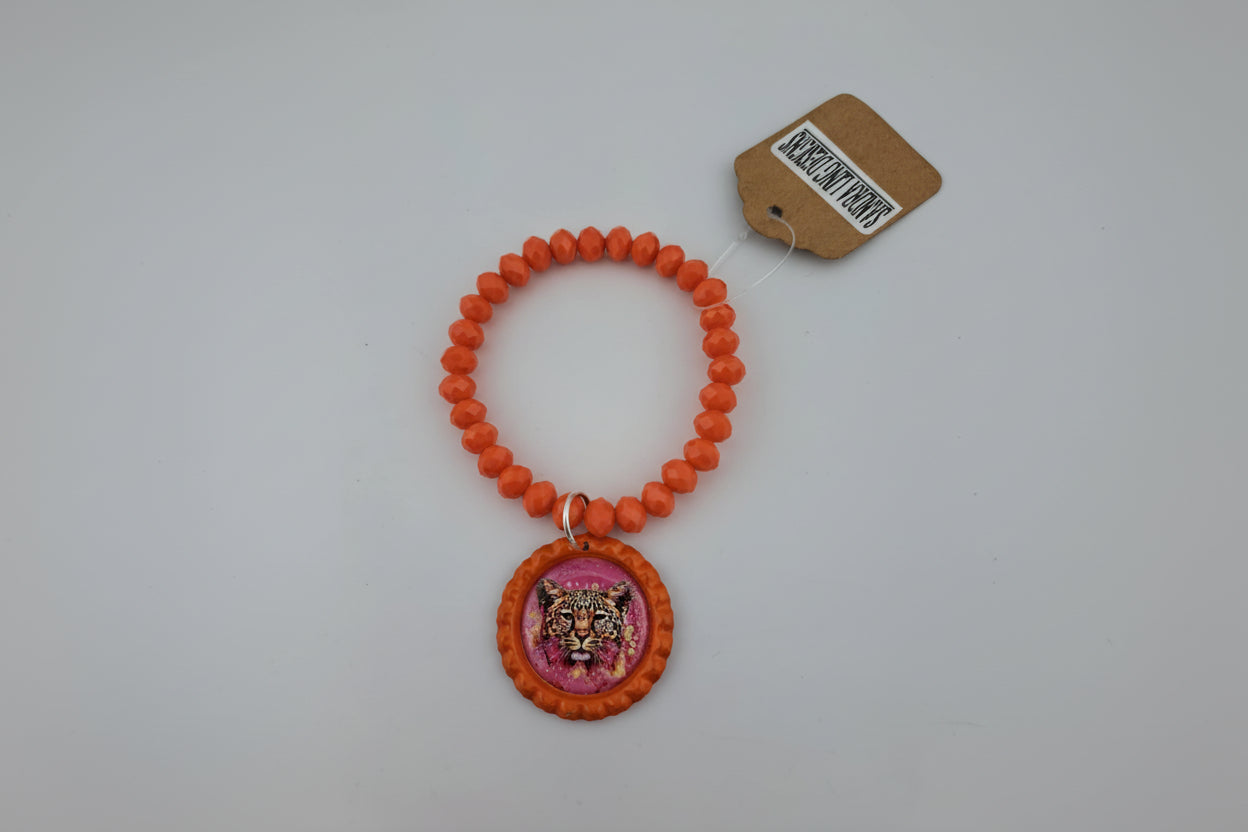 Orange beaded bracelet with a cheetah charm on a white background