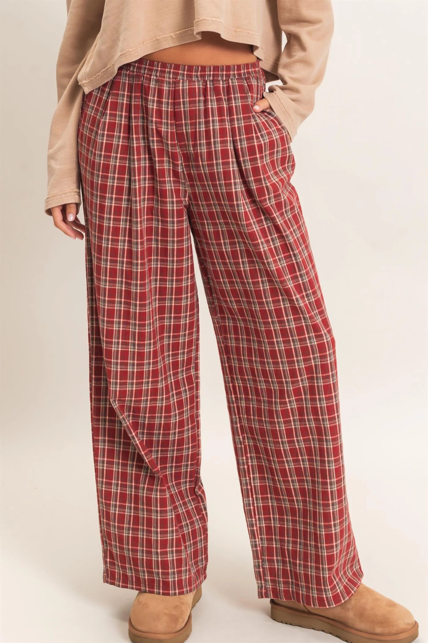 Red plaid pants worn by a person on a white background