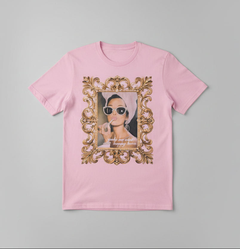 Pink t-shirt with a graphic design in front of a neutral background
