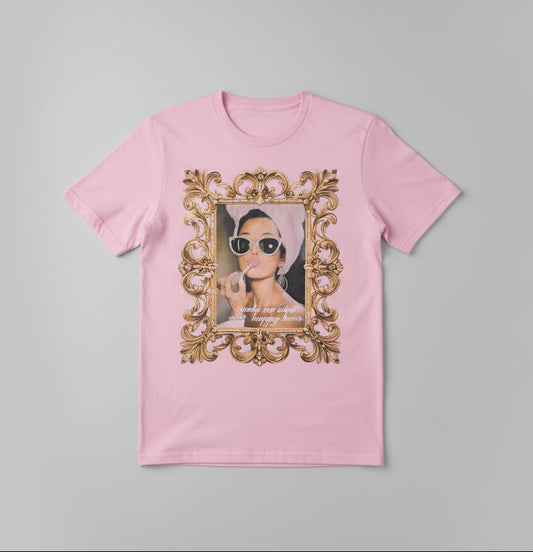 Pink t-shirt with a graphic design in front of a neutral background