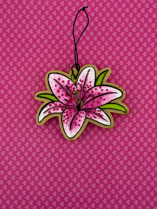 Lily shaped freshie on a pink background with heart patterns