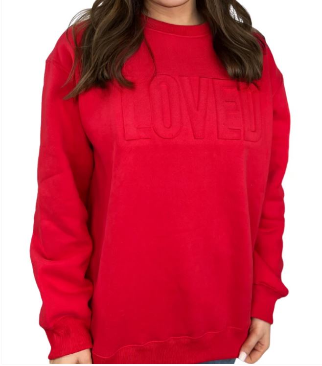 red sweatshirt that says LOVED on a woman with a white backround