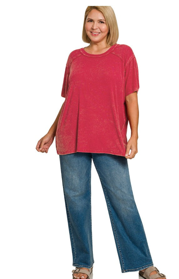 Woman wearing a red top and blue jeans on a white background