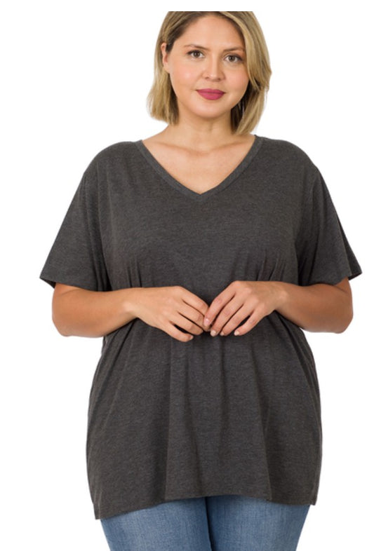 Woman wearing a dark gray t-shirt and blue jeans on a white background
