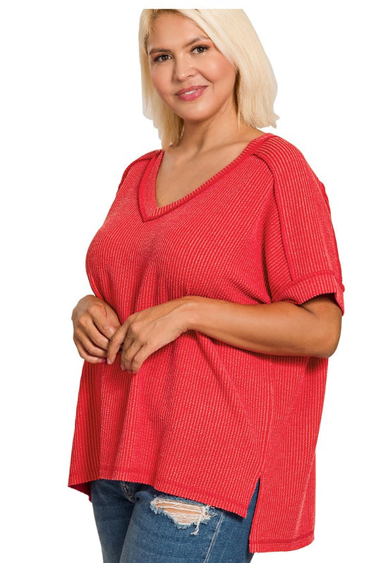 Woman wearing a red textured top on a white background
