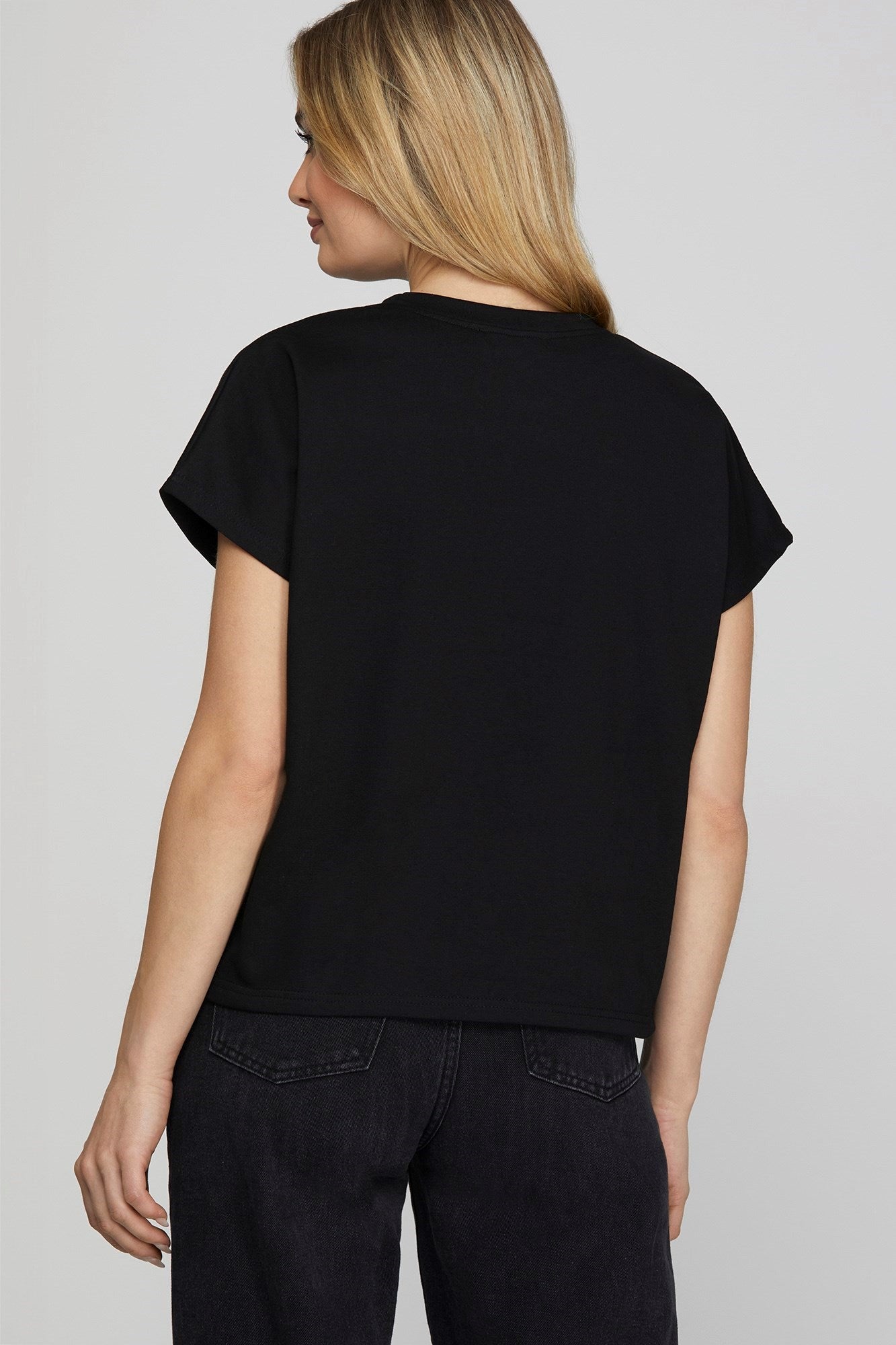 woman wearing a black top, back