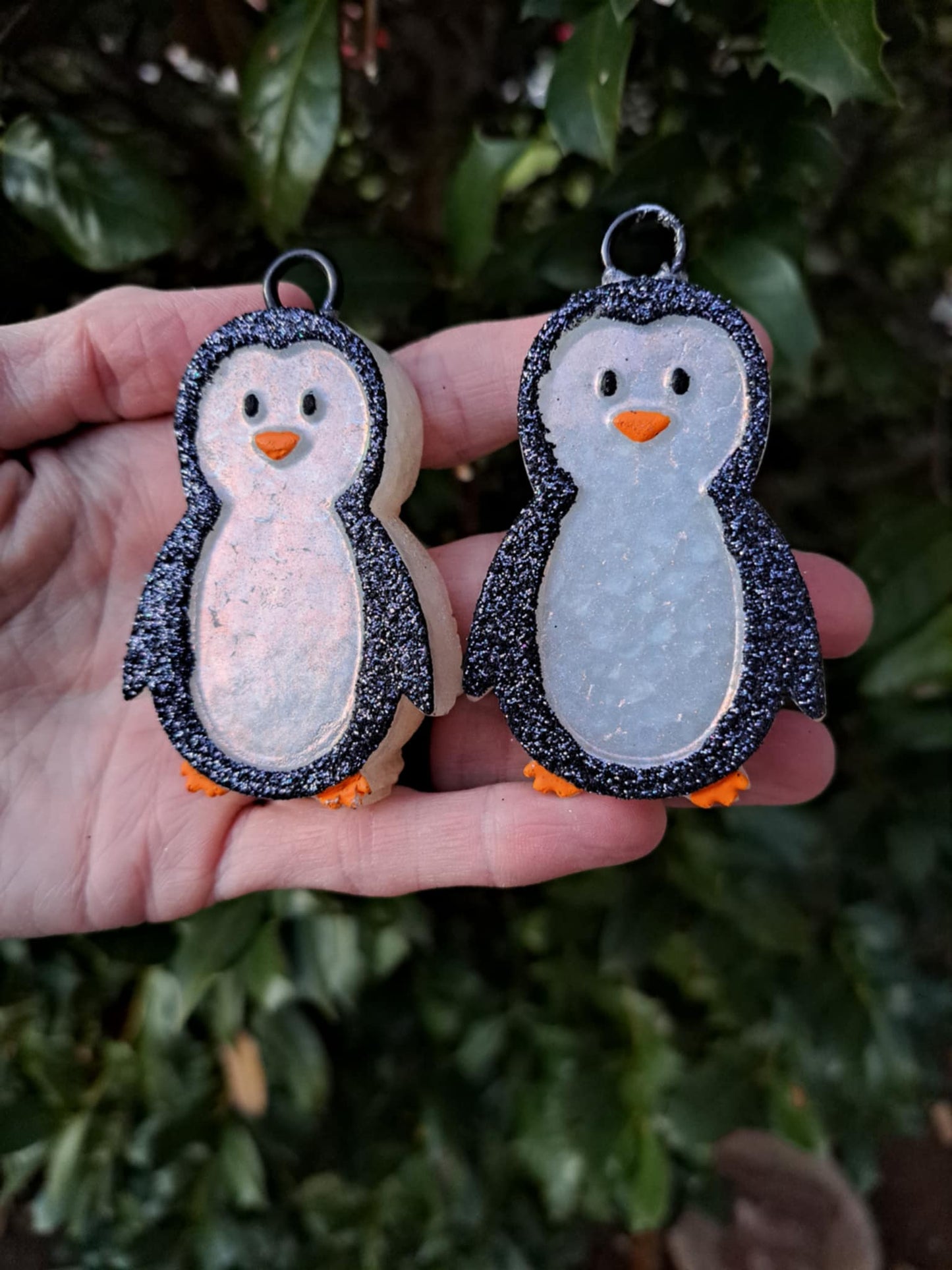 black white penguin vent clips held in front of greenery