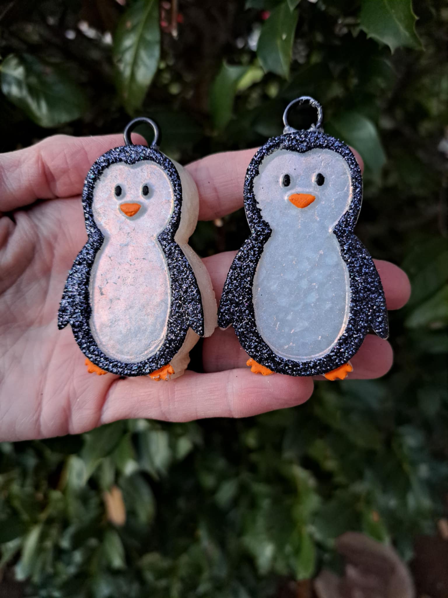 black white penguin vent clips held in front of greenery