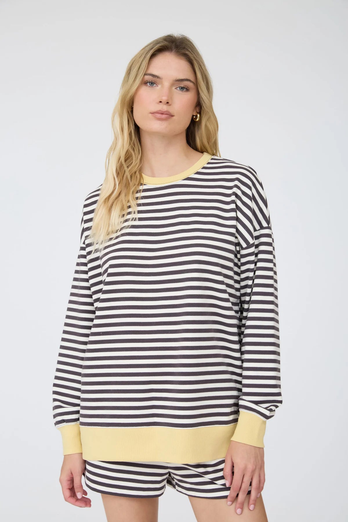 charcoal striped knit top and shorts on a woman standing against a white background
