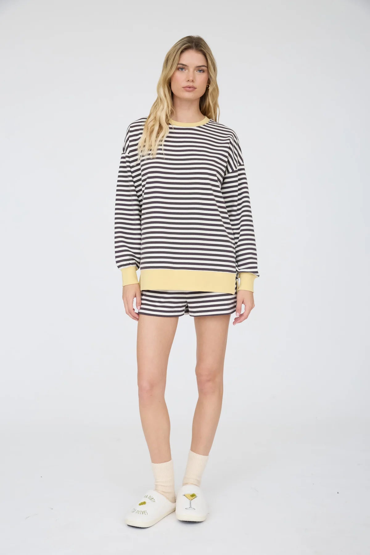 charcoal striped knit top and shorts on a woman standing against a white background wearing house shoes