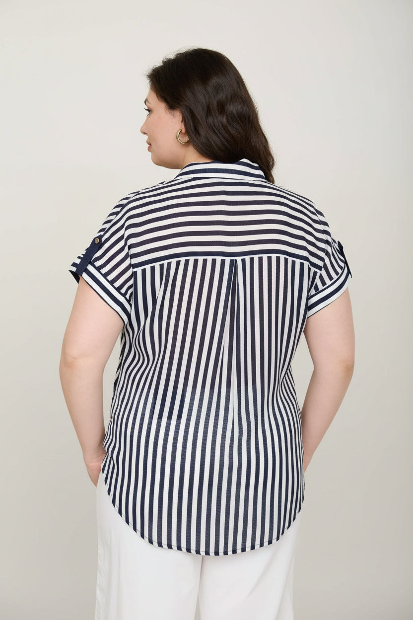 Woman wearing a black and white striped shirt against neutral background