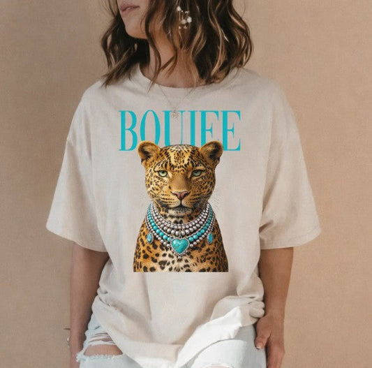 Person wearing a t-shirt with a leopard graphic and 'BOULEE' text on a beige background