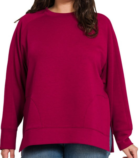 Person wearing a burgundy sweatshirt on a white background