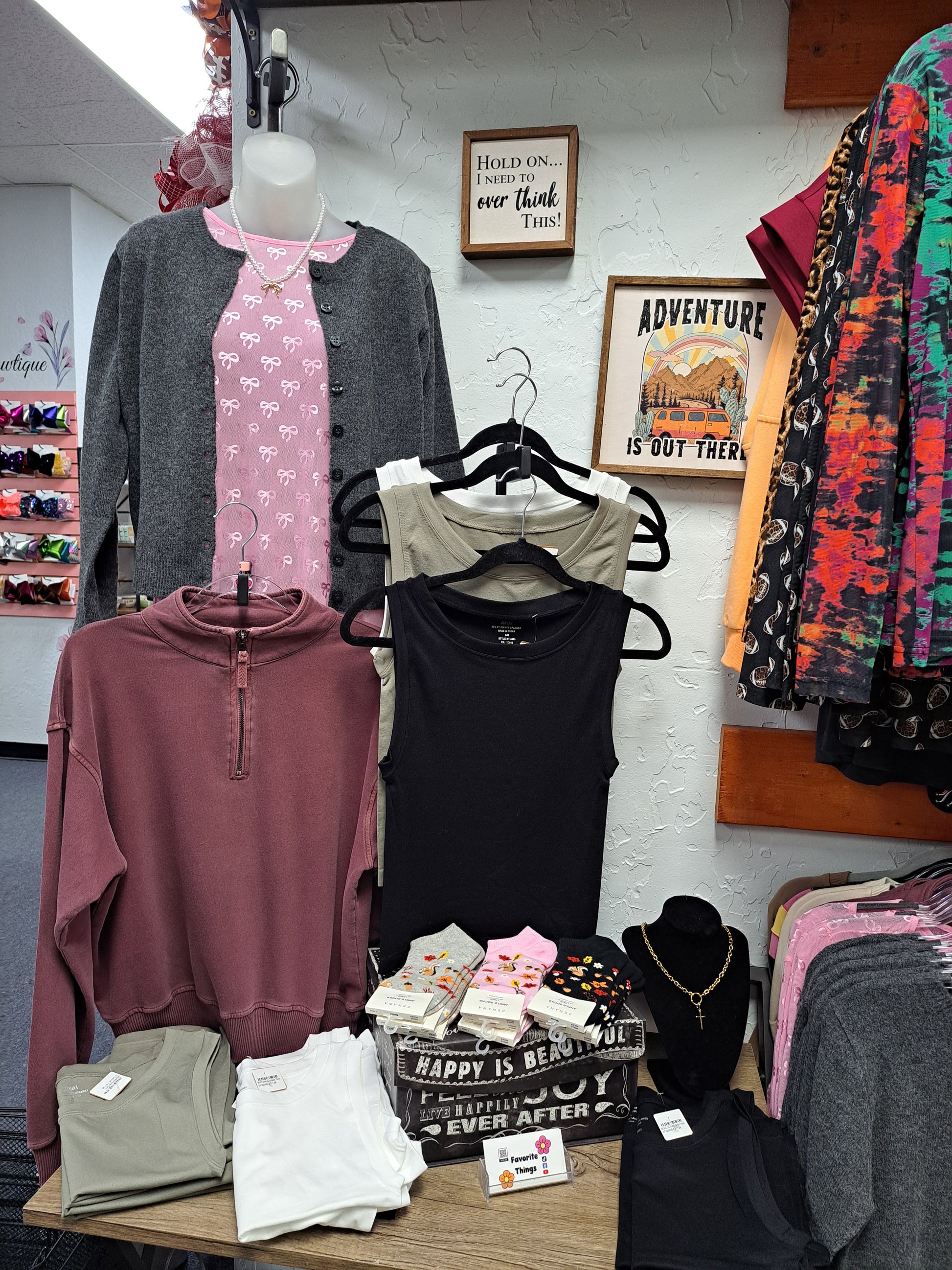 Display of clothing items on hangers and table