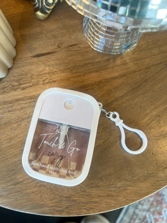 Hand sanitizing mist with keychain on a wooden surface