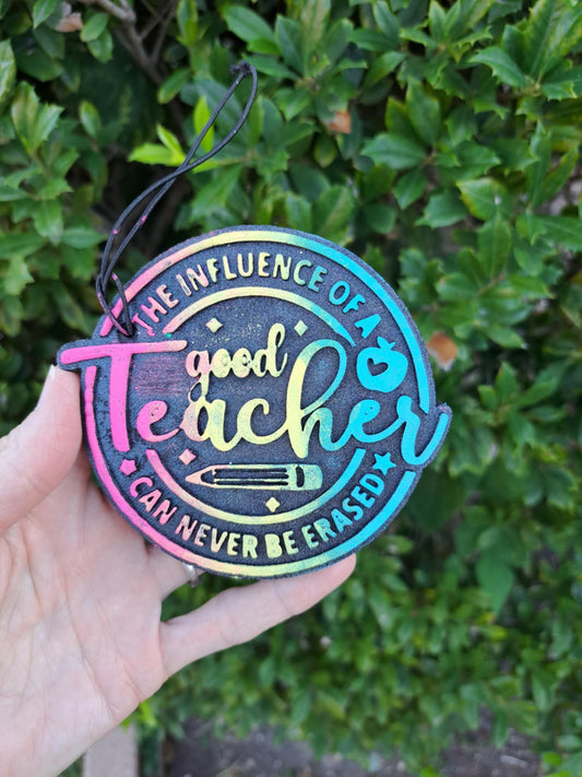 Colorful 'Good Teacher' freshie held in a hand with green foliage background